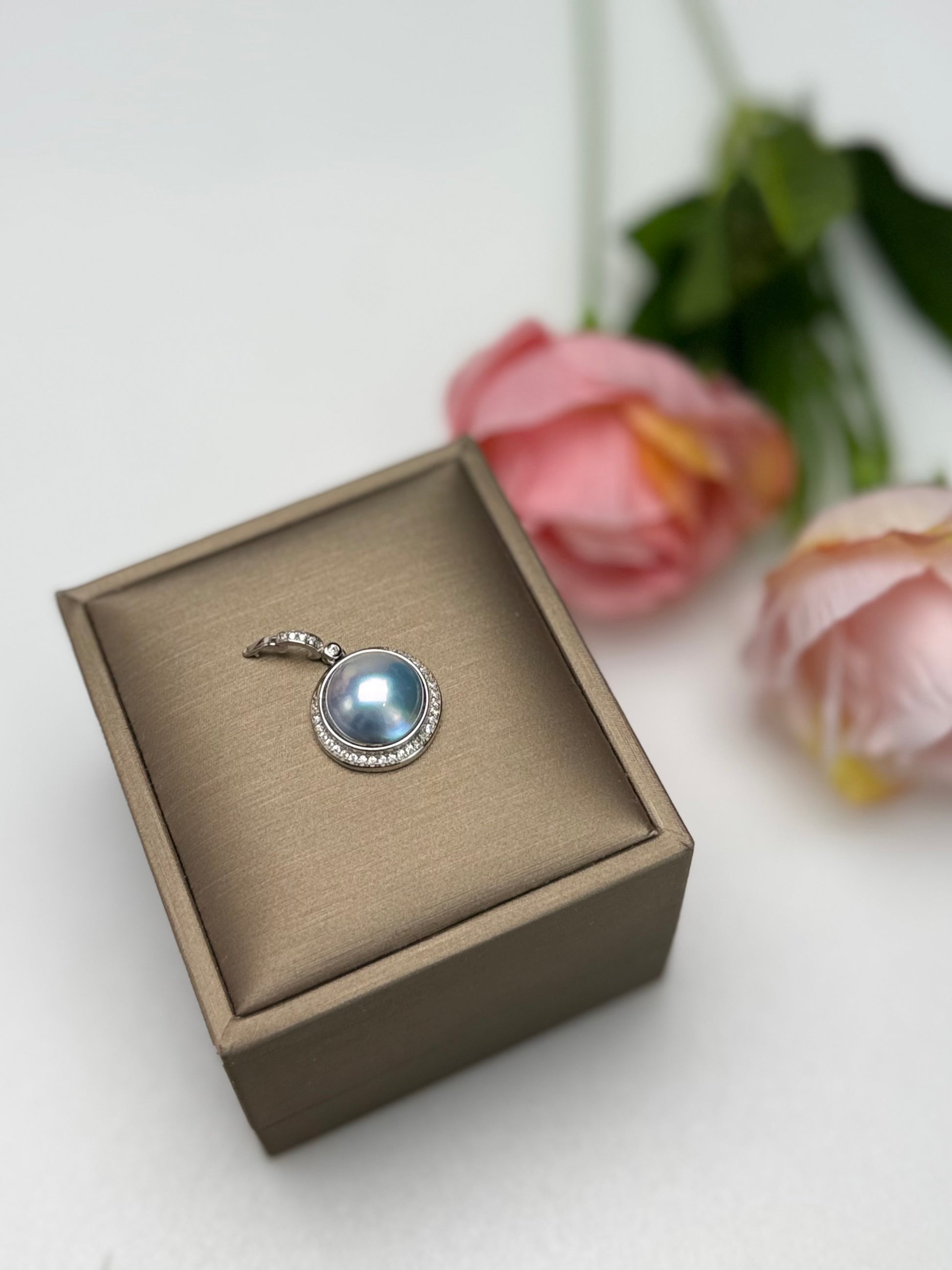 Silvery-Blue Saltwater Mabe Pearl Pendant with Iridescent Overtones.